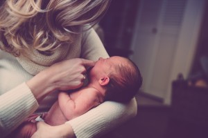 sitting in with your child - mother cradling newborn